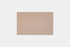 A rectangular, light beige rug with a soft texture, placed on a plain white background.