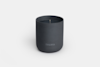 A minimalist dark gray candle in a matte container with the word THUMA printed on the front, set against a plain white background.