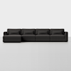 A modern, dark gray sectional sofa with four seats and matching back and seat cushions, set against a plain white background.