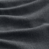 Close-up of dark gray fabric with a textured, woven surface and gentle, wavy folds creating shadow and highlights.