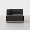 A modern, dark gray upholstered sectional sofa with a left armrest and a light wooden base, set against a plain white background.