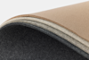 A close-up of several layers of felt fabric in beige, light gray, and dark gray, curved and stacked on top of each other against a white background.