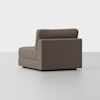 A modern, armless brown upholstered chair with a low backrest and clean lines, positioned on a light-colored floor against a plain white background.