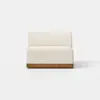 A modern armless sofa with light beige upholstery and a wooden base, positioned on a light gray floor against a plain white background.