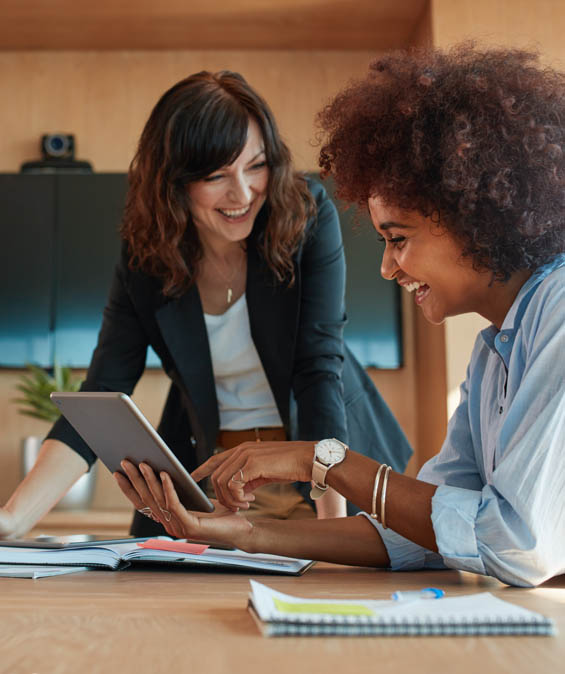 Two partners working together on a tablet