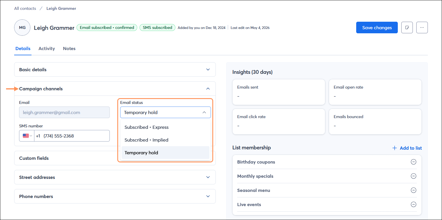 Contact record with Details tab selected, Campaign channel section expanded, and Email status drop-down menu expanded with Temporary hold option selected