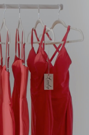 Red dresses on hangers.