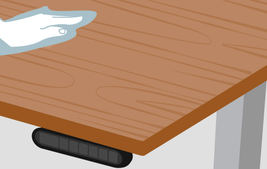 A hand wipes a desktop with a soft, clean cloth.