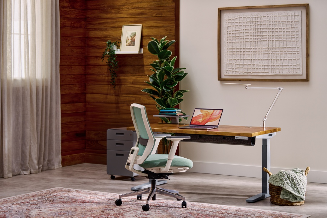 UPLIFT V3 standing desk in gray with a reclaimed birch butcher block desktop