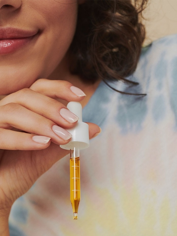 Image - Woman Holding CBD Dropper