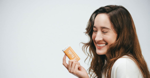 Hero - Young woman smiling while holding Feals CBD mints