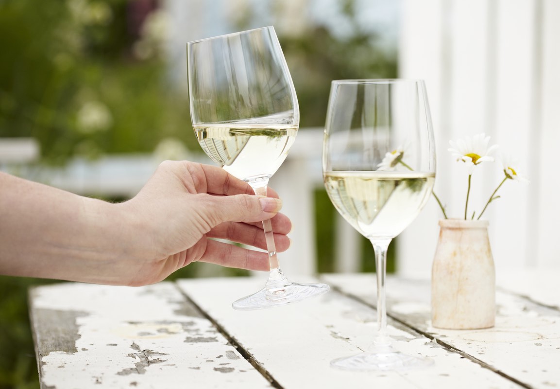 Two white wine glasses on a table