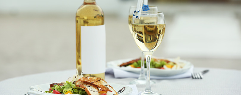 Two glasses of wine accompanying a dinner of chicken salad - German white wine