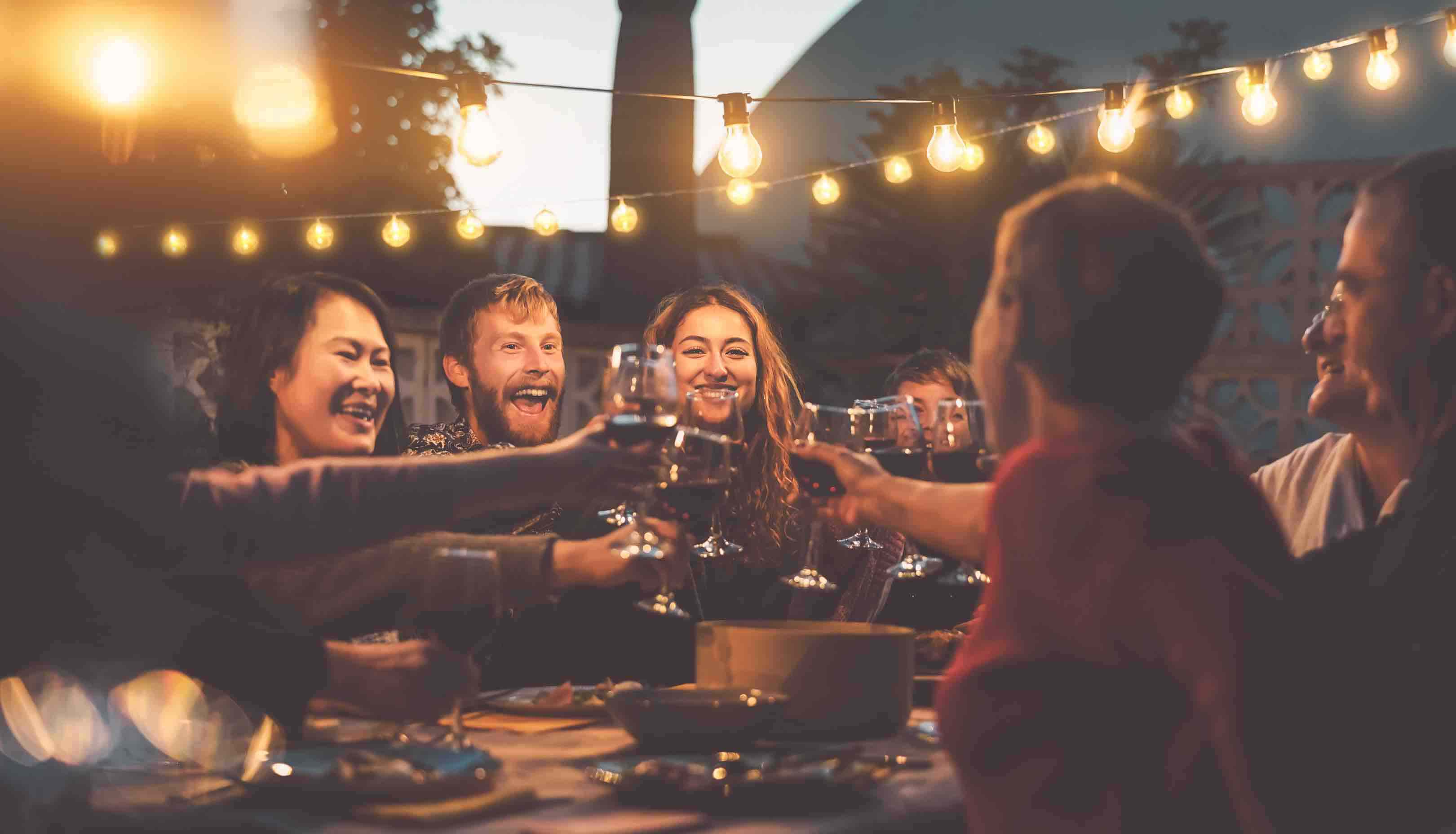 A group of friends toasting with wines in beer garden