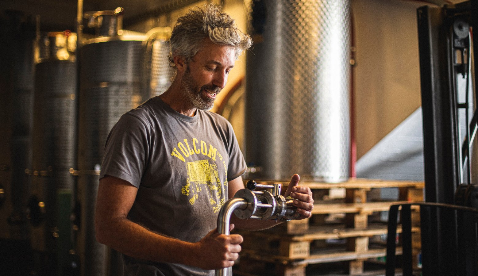  topping up a wine barrel