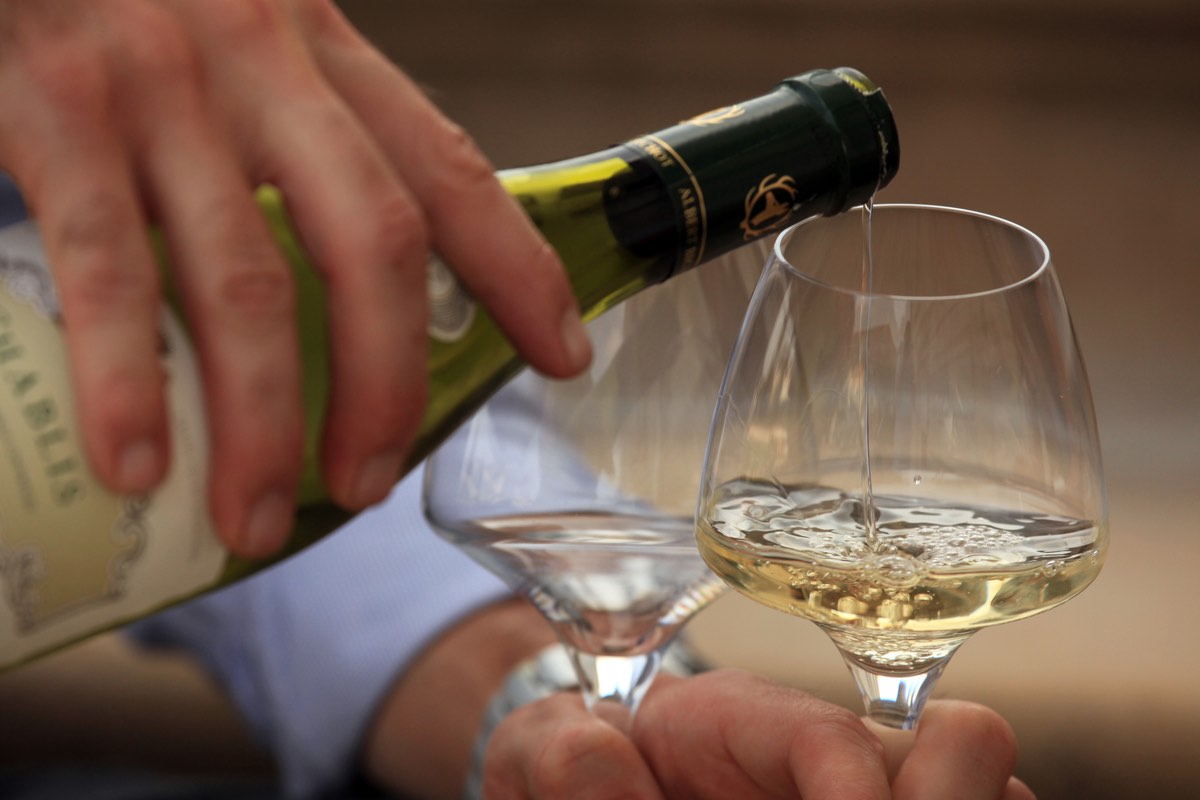 Chablis being poured into wine glass