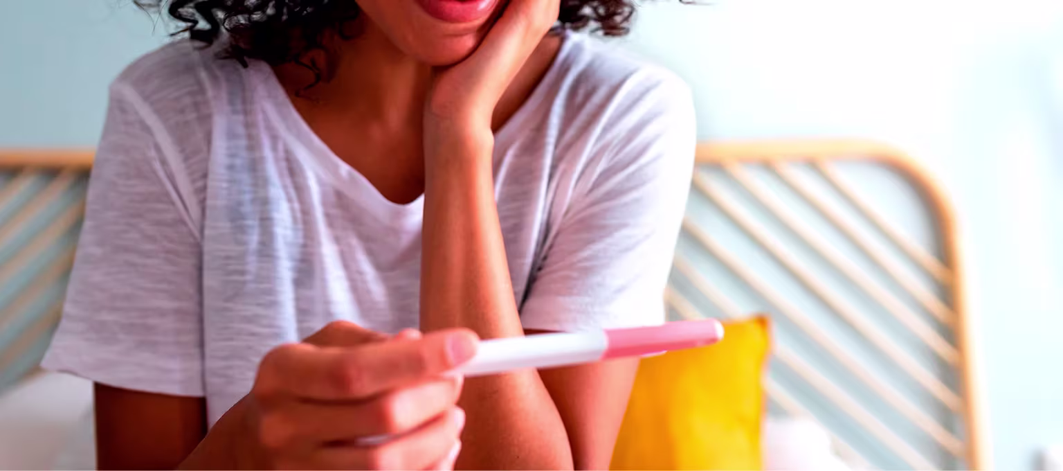 Mujer joven con test de embarazo