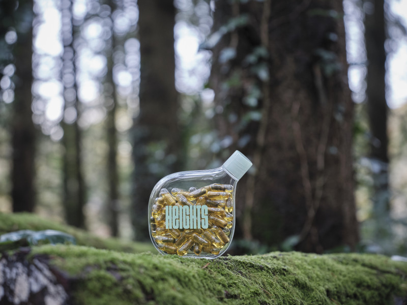 Heights Smart Supplement Bottle in a forest