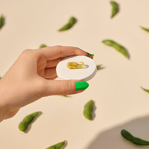 Hand holding single Smart Supplement pill