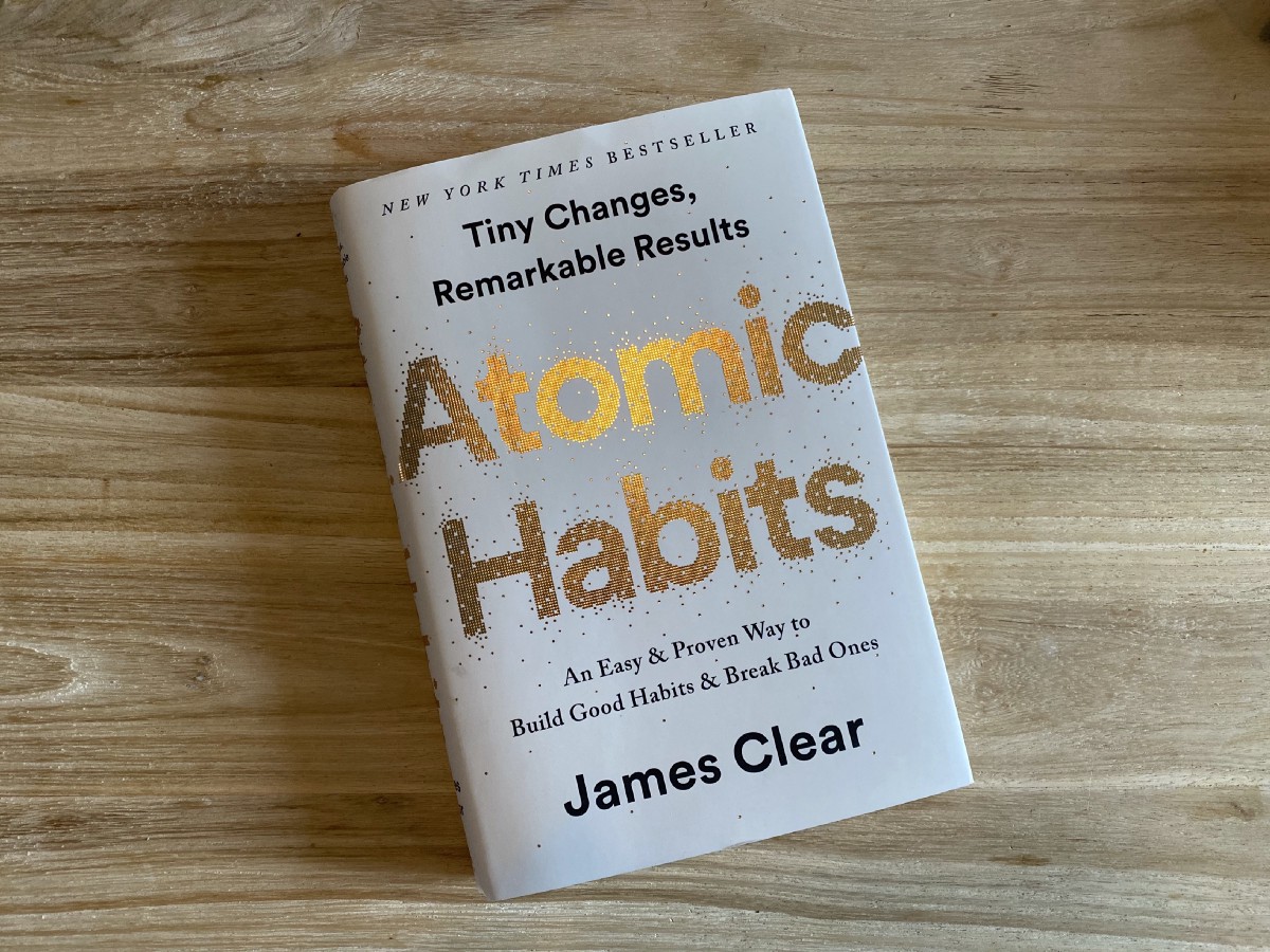 Atomic Habits by James Clear book on the floor 