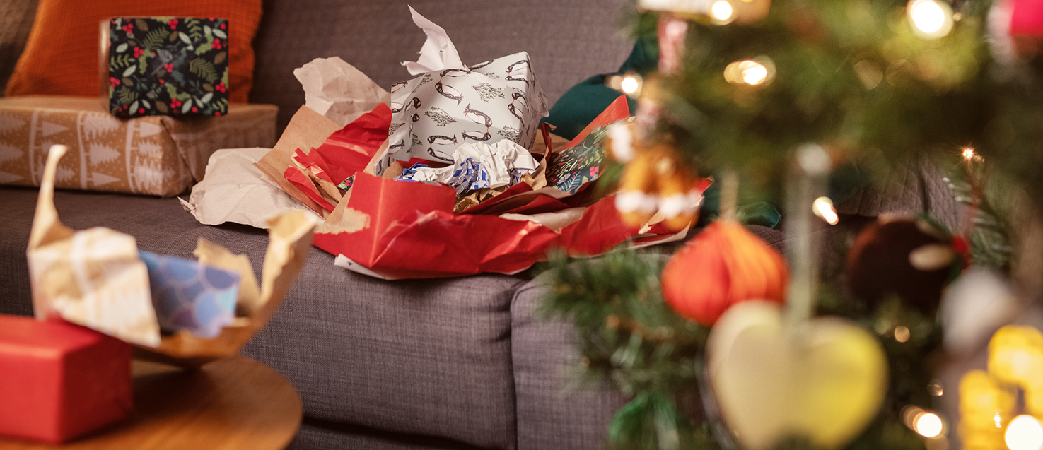 Discarded Christmas Tree With Bow Decoration Wrapped In A White