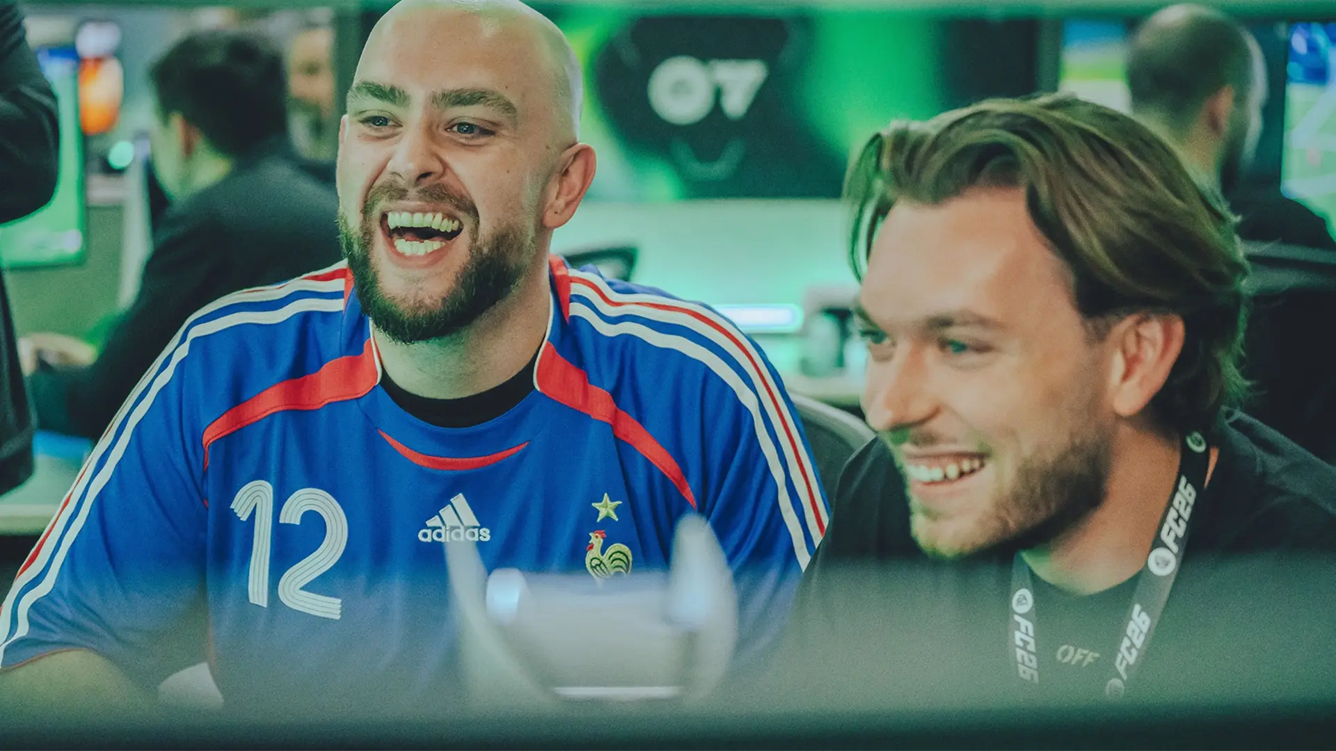 A candid photo of two FC influencers smiling. Captured at FC 26 Reveal Day.