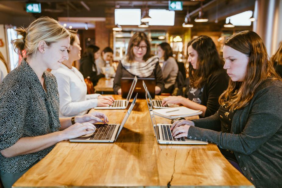 women-on-laptops-around-table 925x