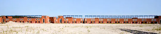 Red houses in a row with solar panels on their roofs