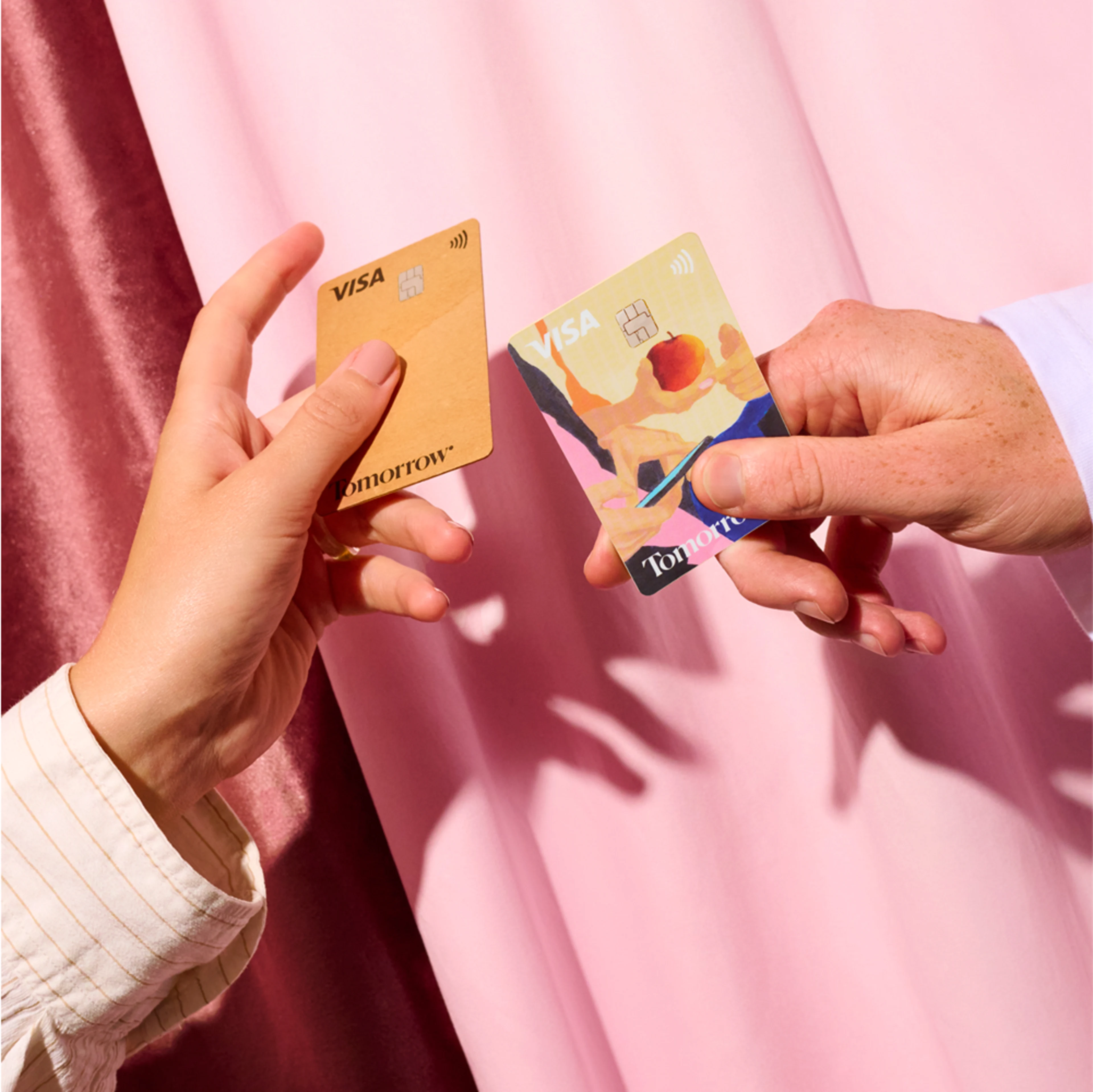 Two people holding two different Tomorrow Cards in their hands