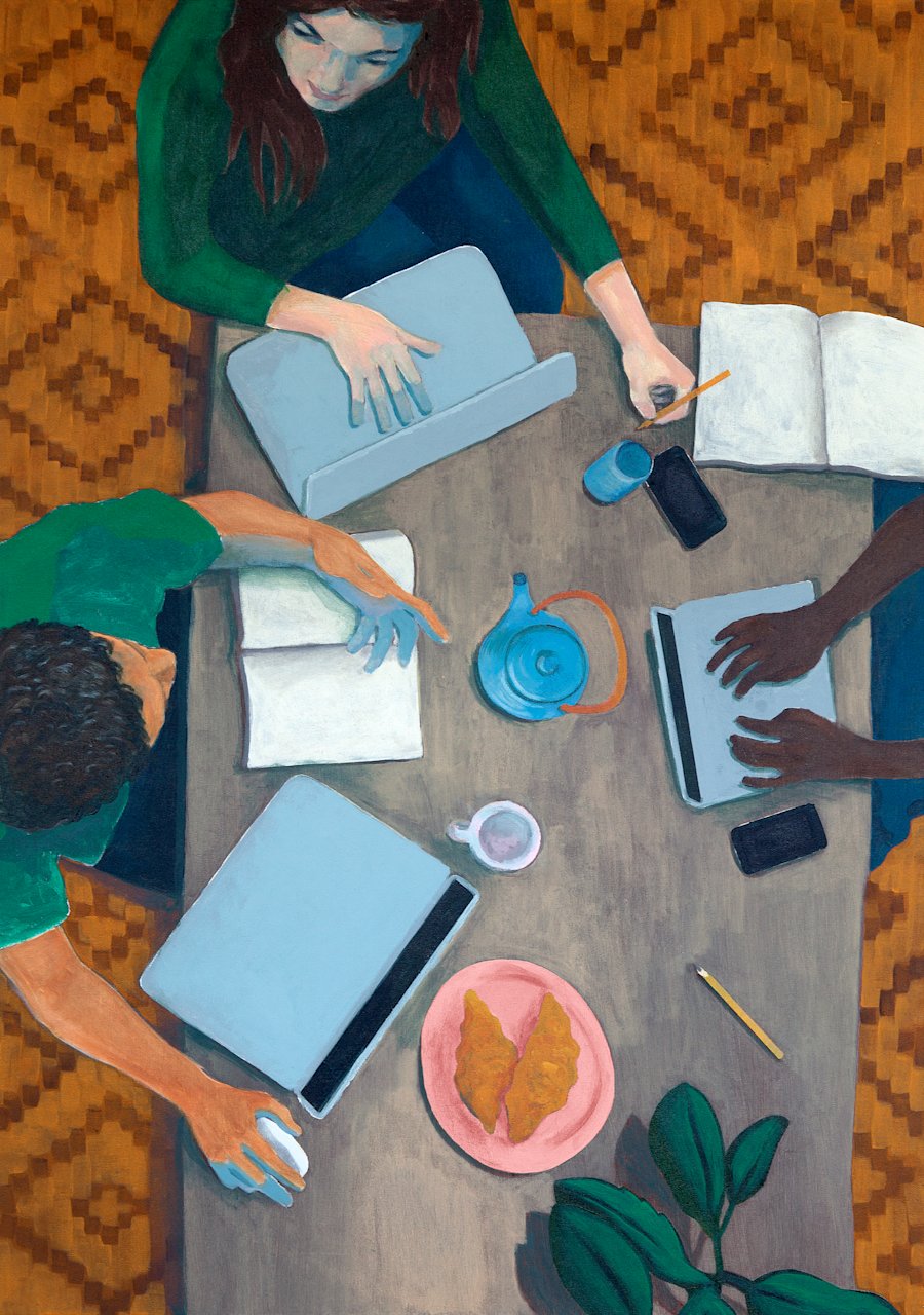 Top view of three people sitting on a table with laptops, smartphones a notebook