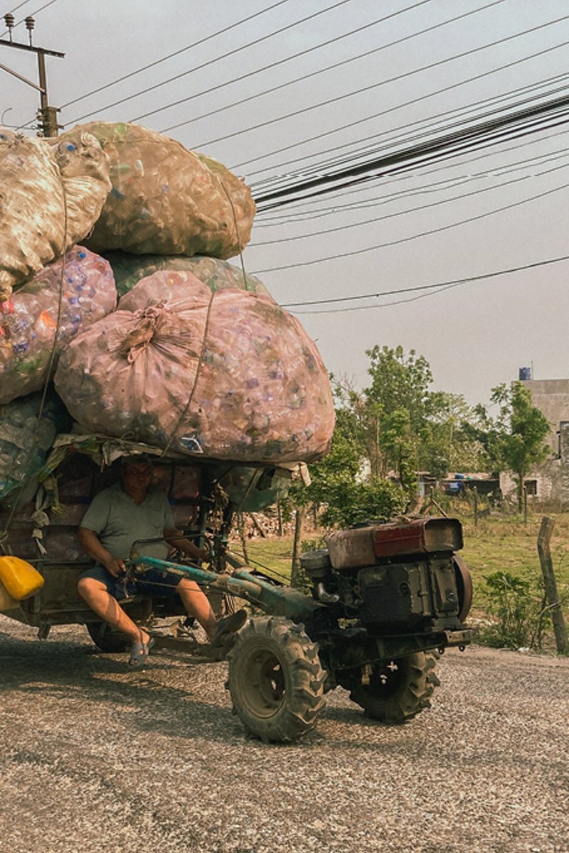 Man on a bike who transports a lot of plastic.