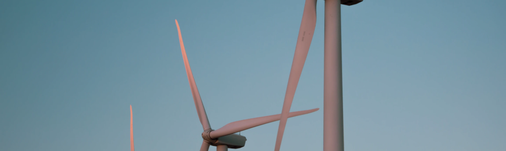 Three wind turbines with dark blue sky