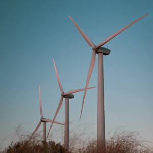 Three wind turbines with dark blue sky