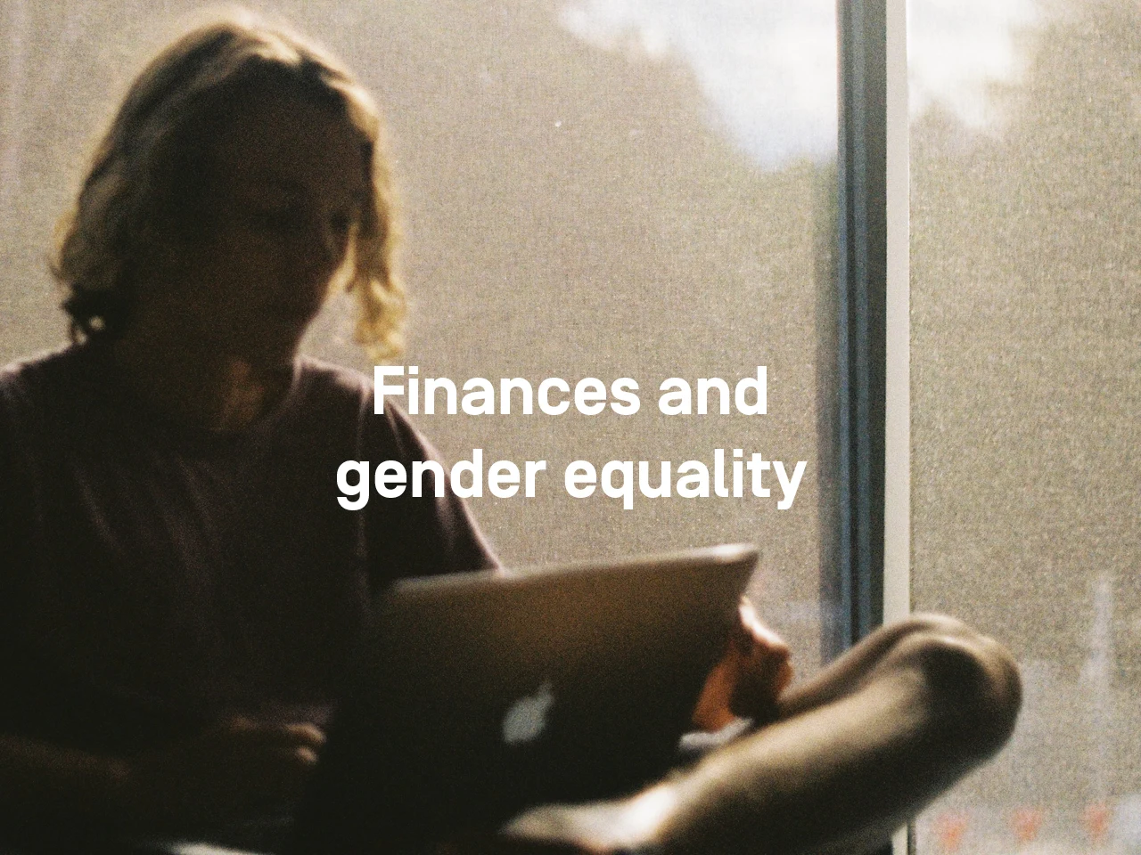 Woman with laptop: text: Finances and gender equality