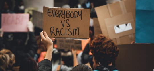 Plakat mit der Aufschrift: Everybody vs racism