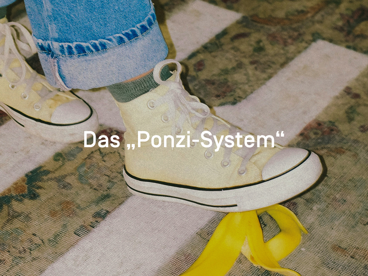 Es sind nur die gelben Chucks einer Person zu sehen, die auf einem Teppich auf eine Bananenschale treten.