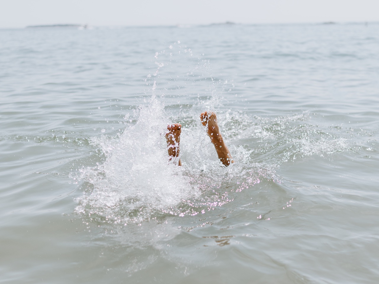 Person jumping into water