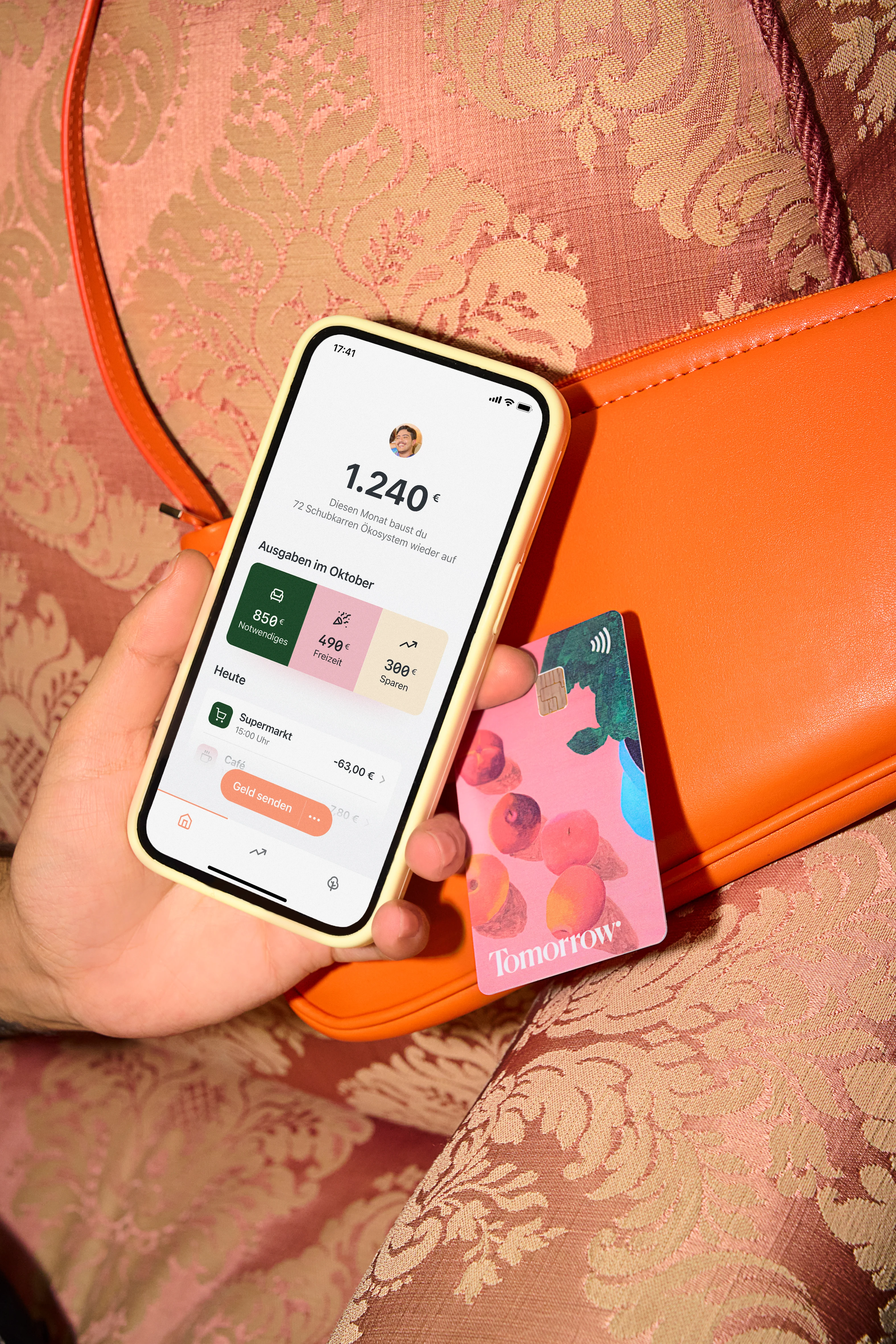 A person is holding a smartphone with the Tomorrow app open and visible on the screen.