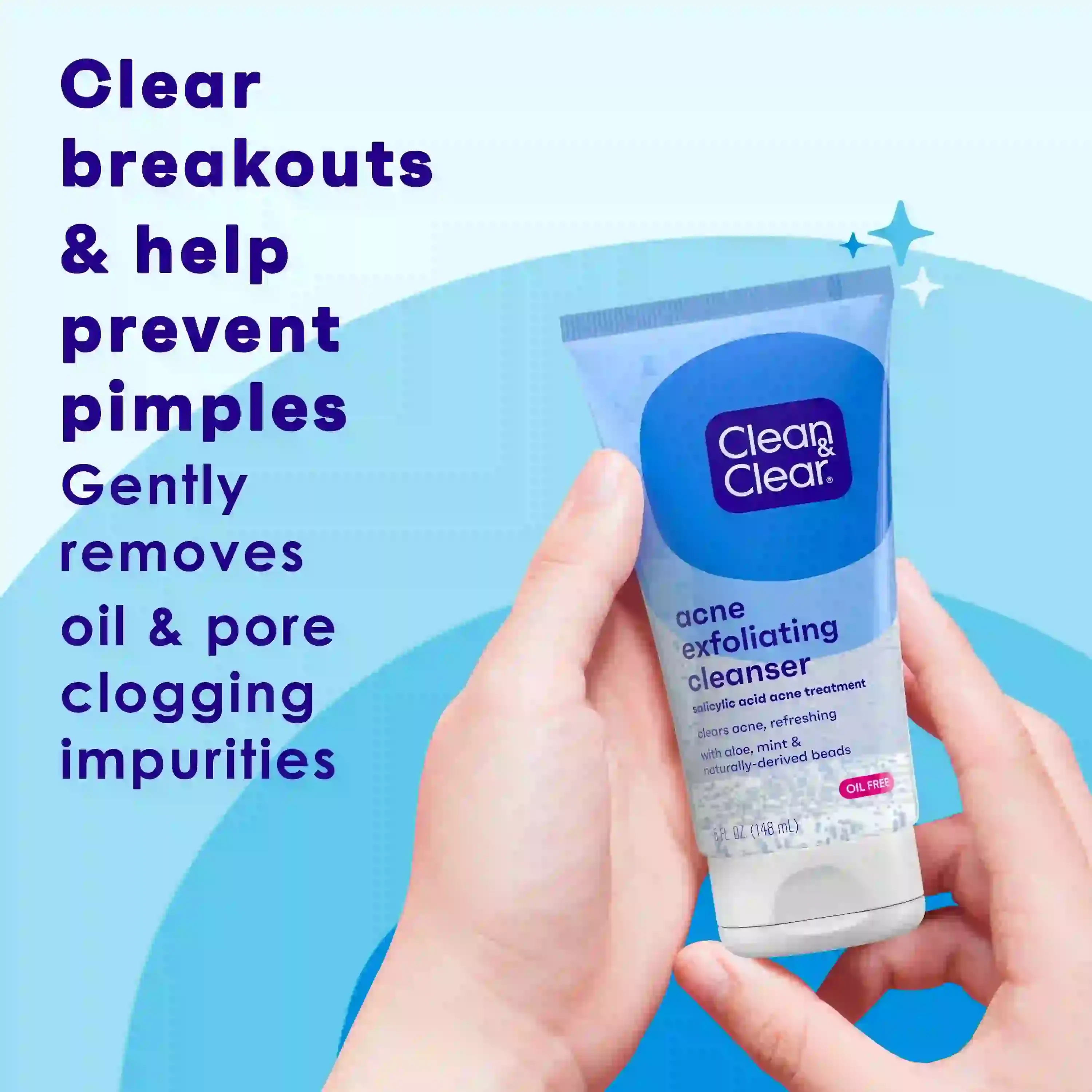 Hands holding a "Clean & Clear" acne exfoliating cleanser tube against a blue background. Text reads: "Clear breakouts & help prevent pimples. Gently removes oil & pore clogging impurities."