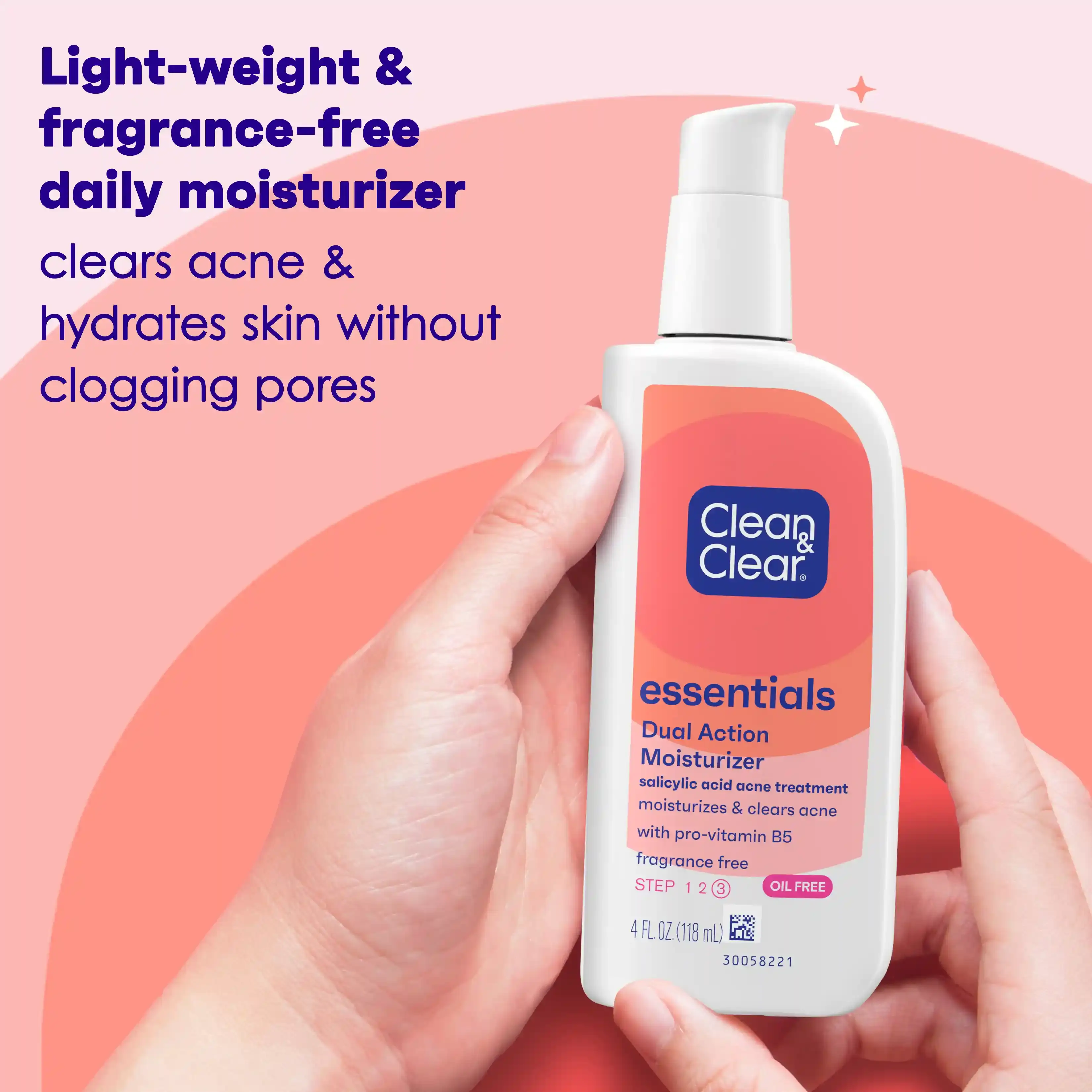 Hand holding Clean & Clear® Essentials Dual Action Moisturizer bottle with salicylic acid