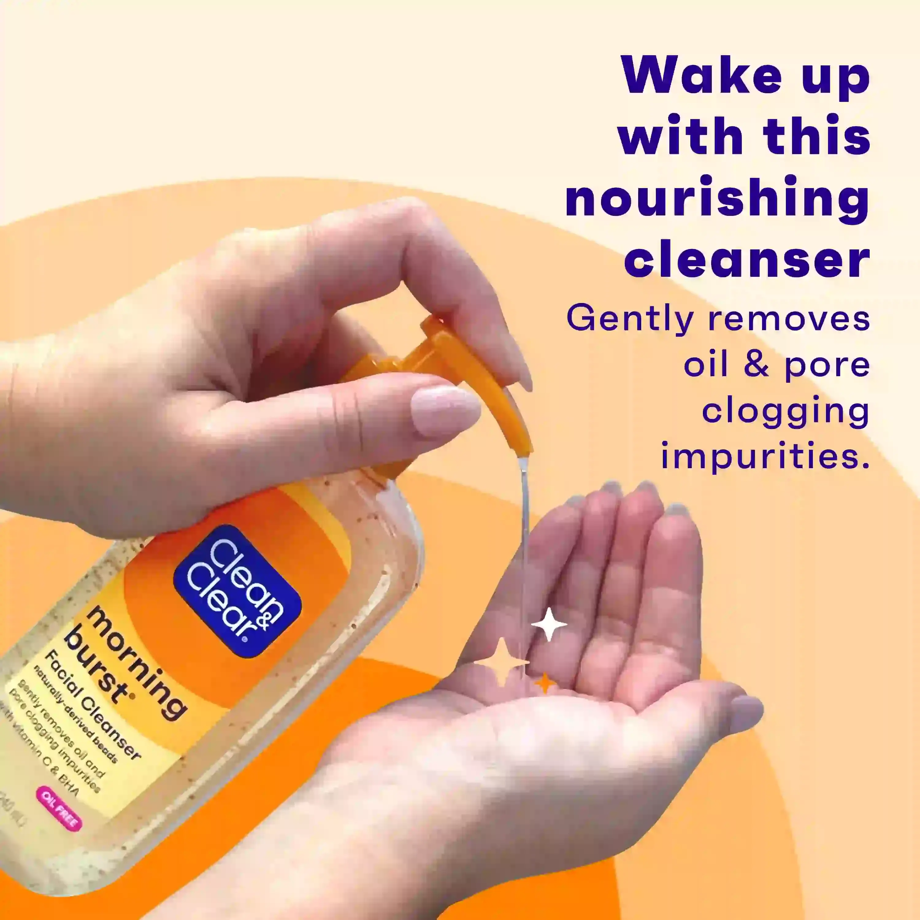 Hands dispense Clean & Clear morning burst facial cleanser from an orange pump bottle onto a palm. Text: "Wake up with this nourishing cleanser. Gently removes oil & pore clogging impurities."