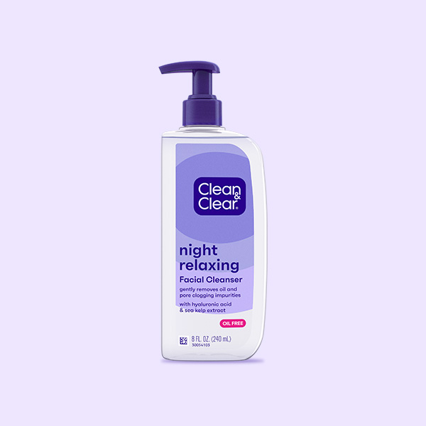 A bottle with a pump dispenser labeled "Clean & Clear night relaxing Facial Cleanser" stands against a plain background. Text reads: "gently removes oil and pore clogging impurities with hyaluronic acid & sea kelp extract, OIL FREE, 8 FL OZ (240 mL)."
