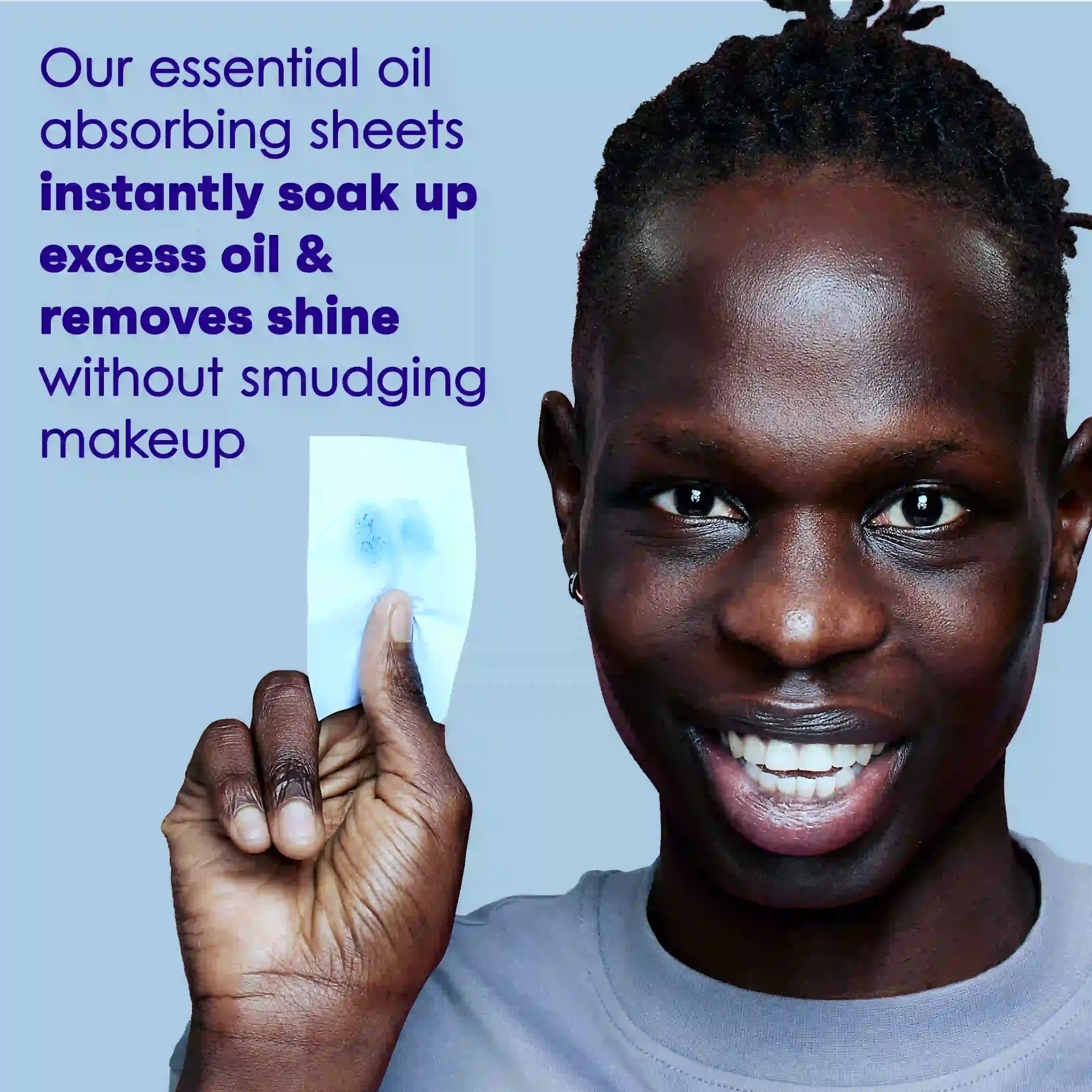 Person holding oil absorbing sheet that instantly soaks up excess oil without smudging makeup