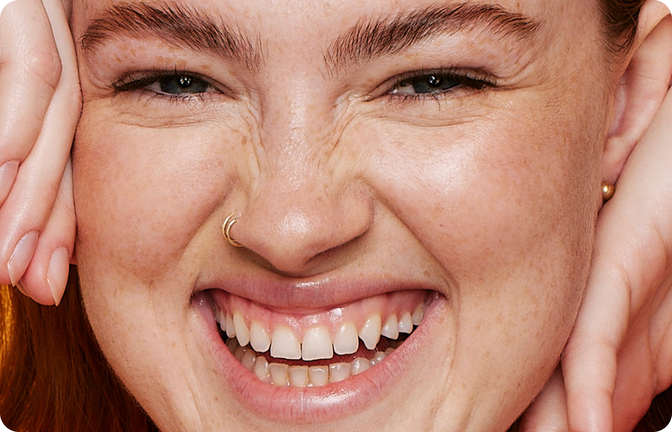 Close-up of a smiling person with glowing skin, exemplifying effective skincare basics.