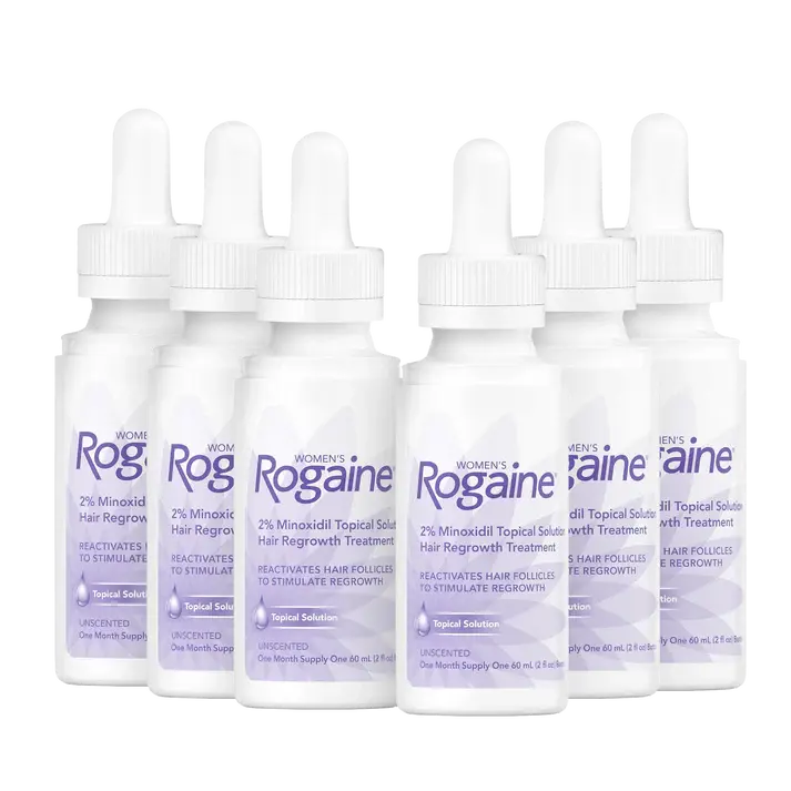Six purple bottles of Women's ROGAINE® Topical Solution on a white background.