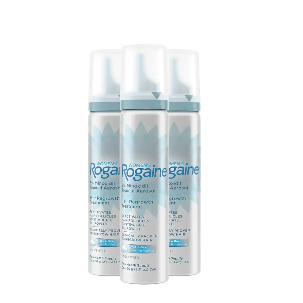 Three silver bottles of Women's ROGAINE® Foam on a white background.