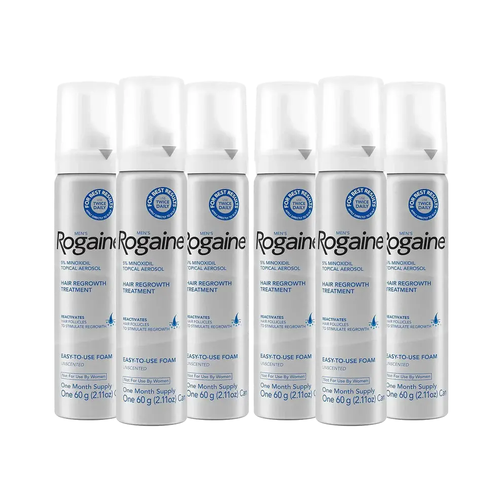 Six silver bottles of Men's Rogaine Foam Solution on a white background.