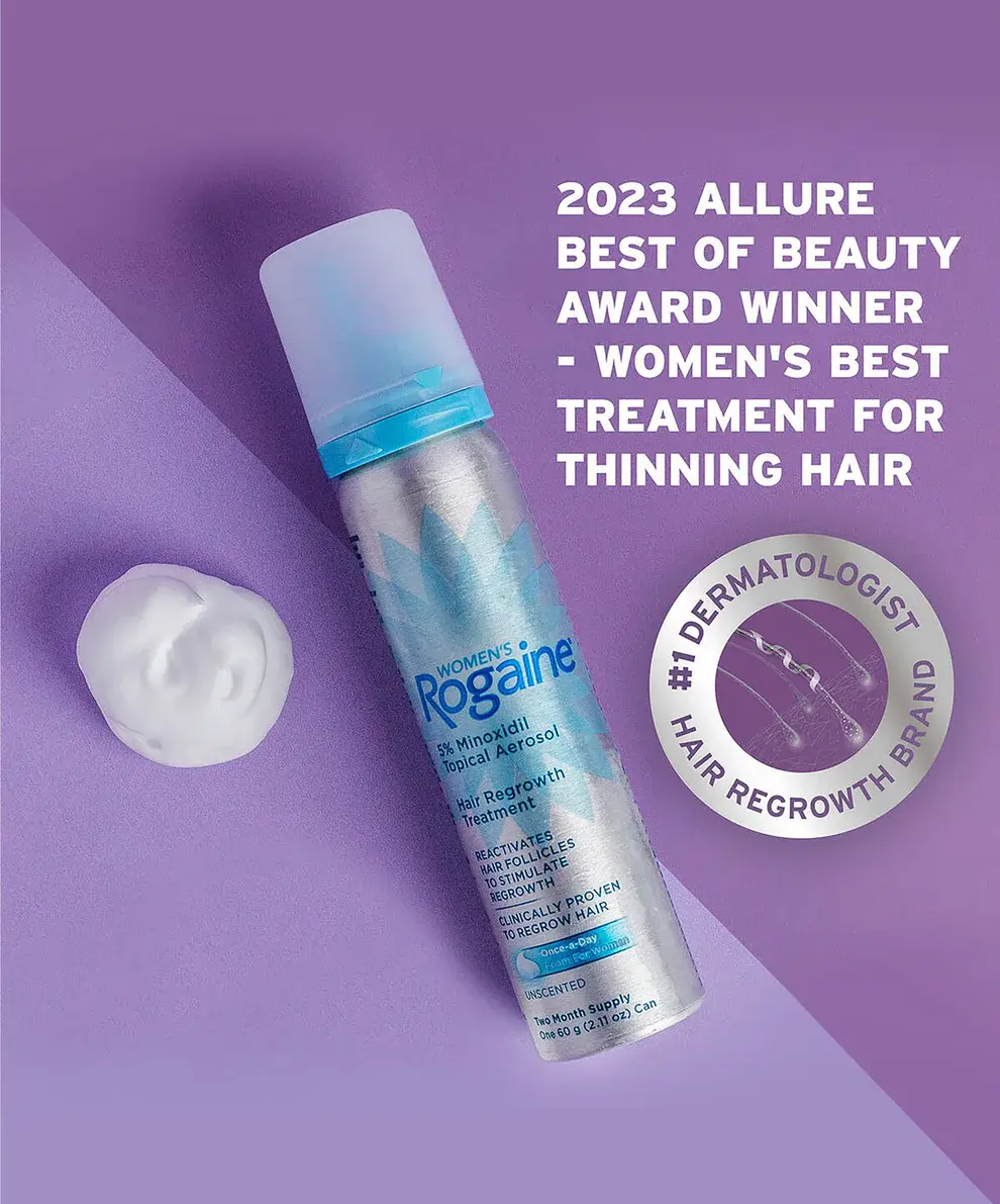 2023 Allure Beauty Award Winner Women's ROGAINE® Foam Solution Bottle and dollop on a purple background.