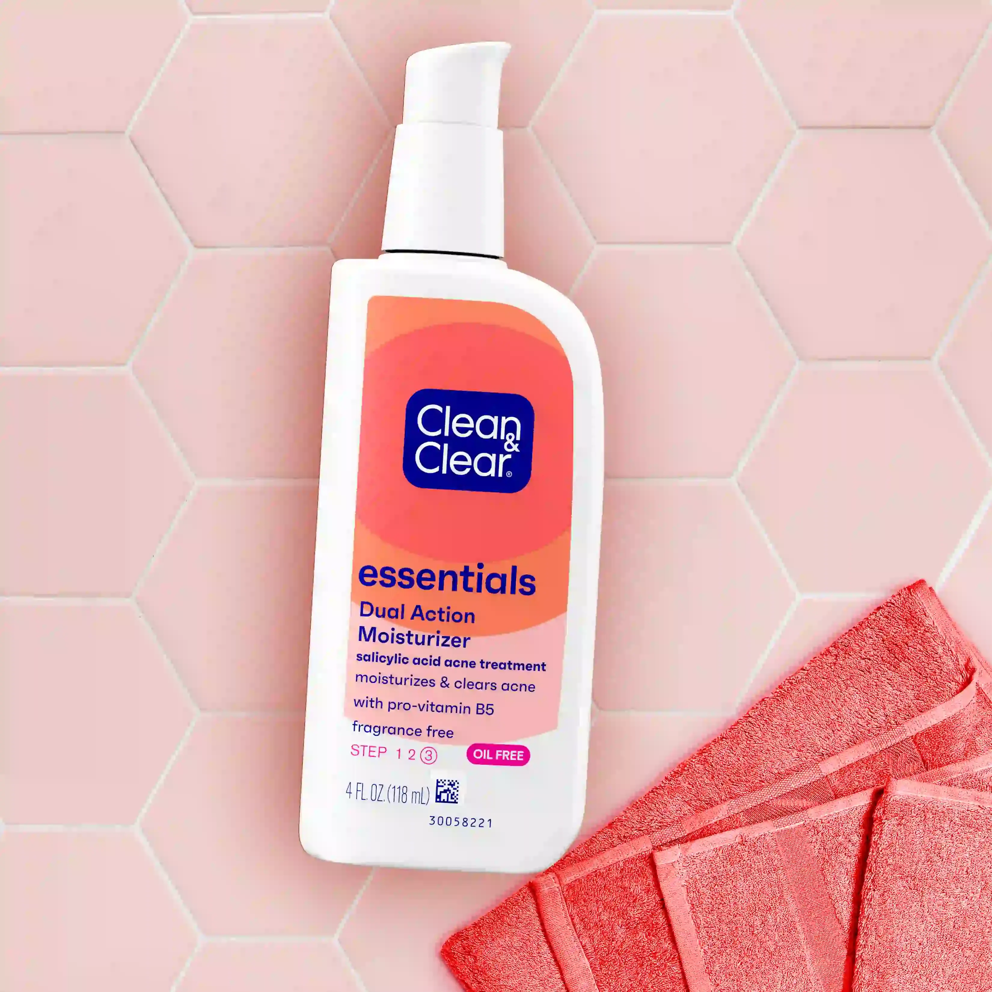 Clean & Clear® Essentials Dual Action Moisturizer 4 fl oz bottle on pink hexagon tile with towel