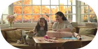 Smiling mother and daughter with pet dog.